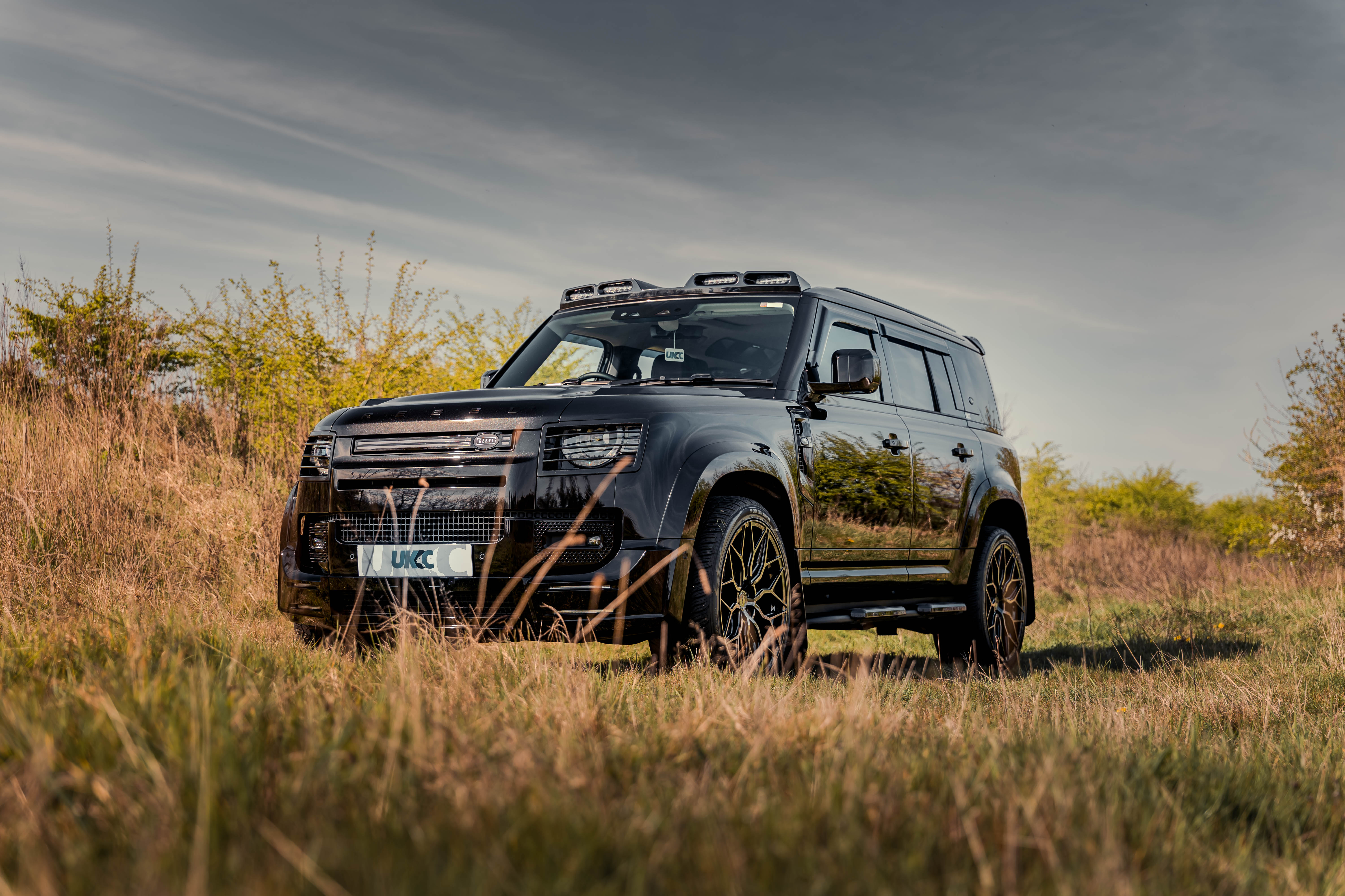 UKCC Rebel Land Rover Defender on farmland, cinematic automotive photography